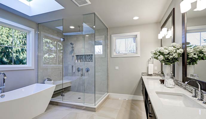 A modern, high-end bathroom featuring a frameless glass shower enclosure