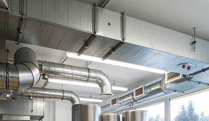 An interior view of a commercial ceiling featuring HVAC ducts