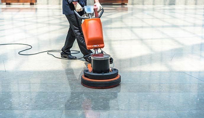 A person cleaning a commercial building floor