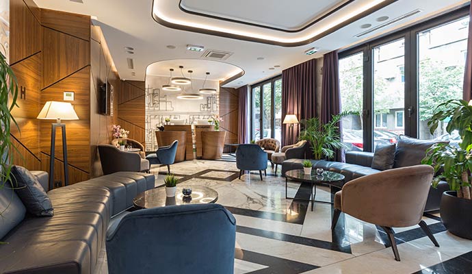 Hotel lobby with tidy seating area and polished floors.