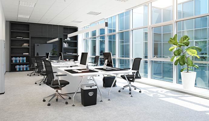 Modern office workspace large windows desks