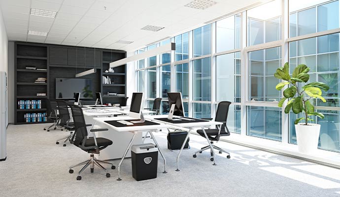 Clean office workspace with desks and chairs