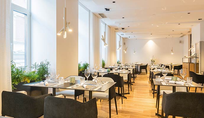 Freshly cleaned restaurant dining area with set tables and clear walkways.